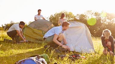 Freunde bauen Zelt auf  - Foto: iStock / monkeybusinessimages