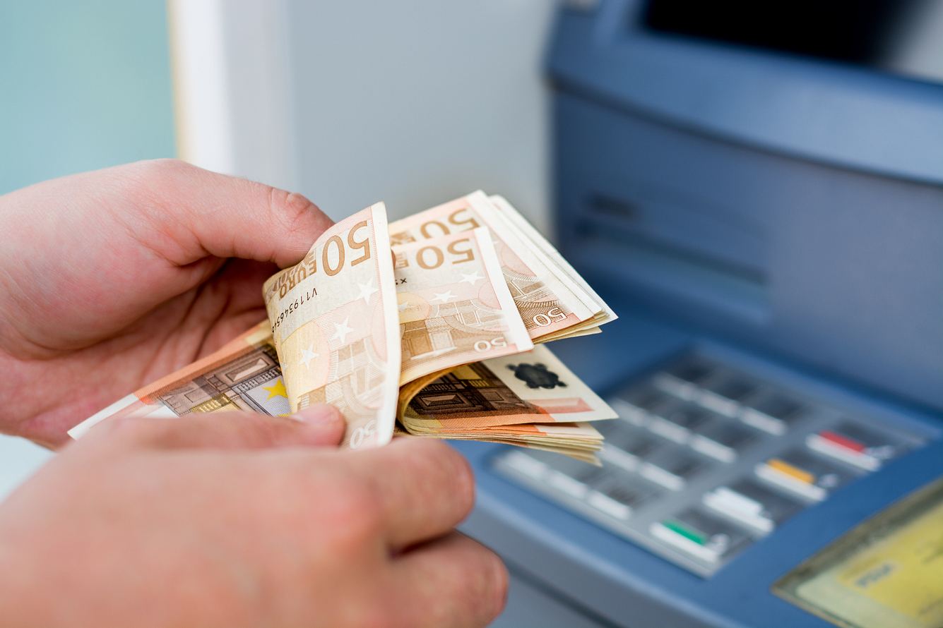Geldscheine vor Bankautomat