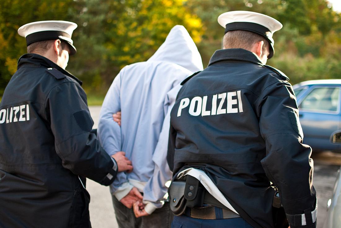 Junger Mann wird von Polizei abgeführt Junger Mann wird von Polizei abgeführt