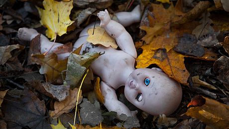 Creepy Puppe auf dem Waldboden - Foto: iStock / toxawww