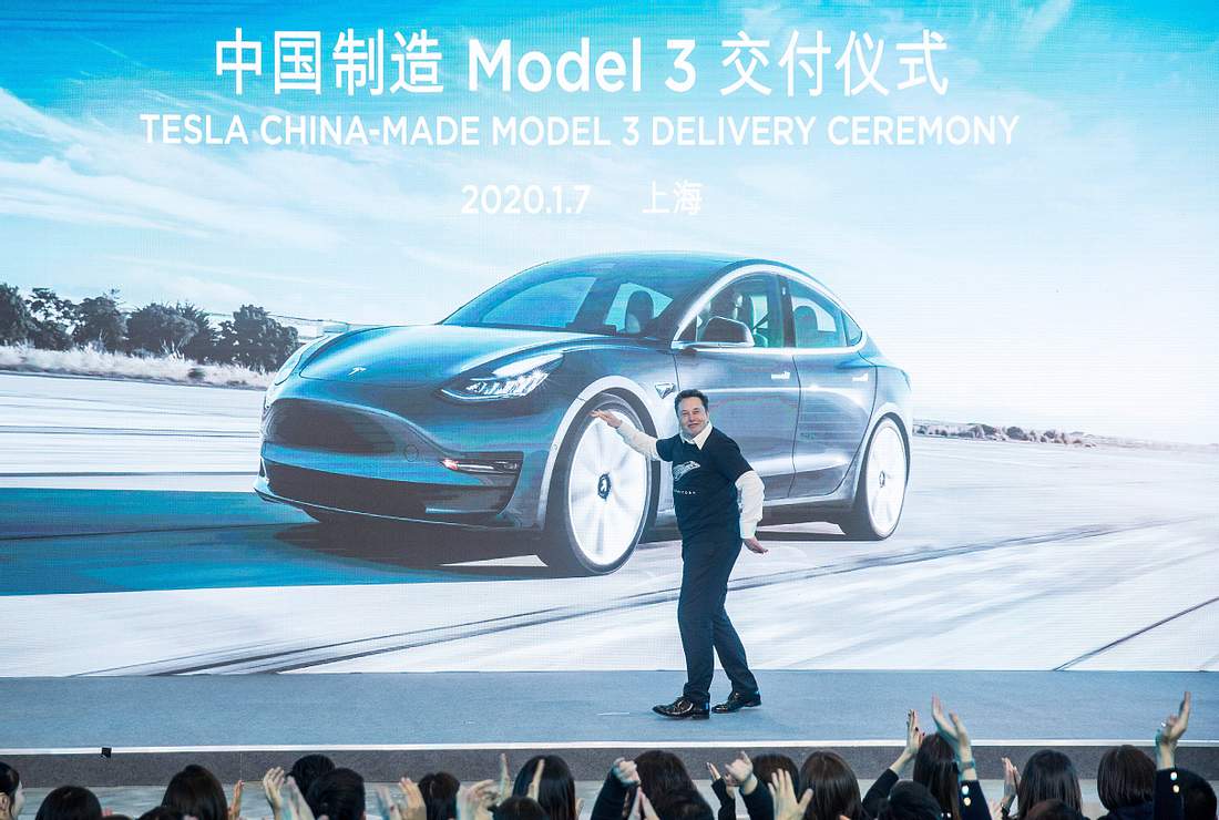 Tesla-Chef Elon Musk stellt sein Model-3 vor Elon Musk auf Bühne vor Bild eines Tesla Model-3