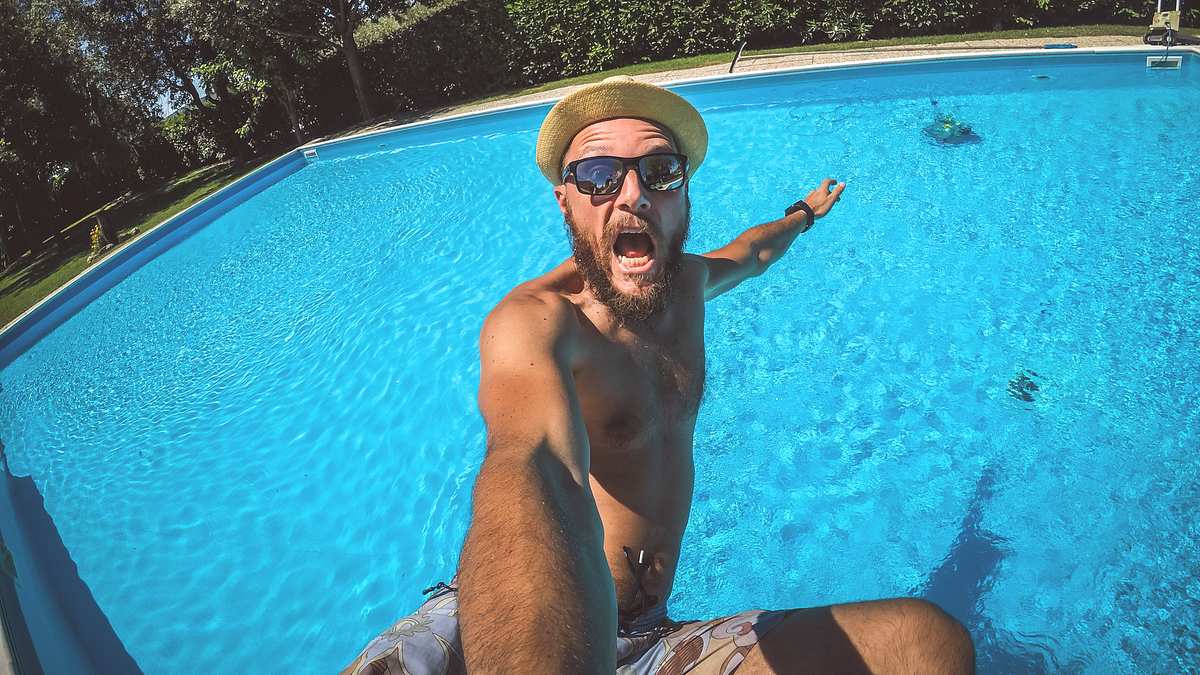 Mann macht Selfie, während er in Pool fällt